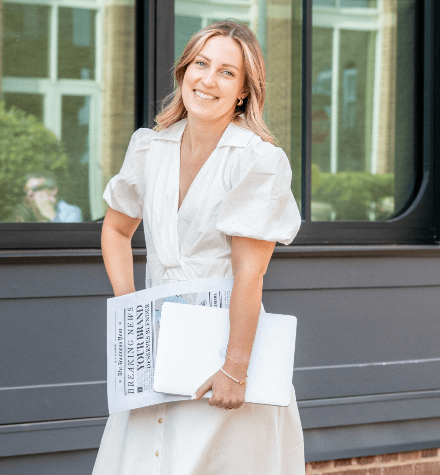 Lauren Cooper, owner of a Branding Studio for Small Businesses, holding a magazine outside of Morrisville branding studio