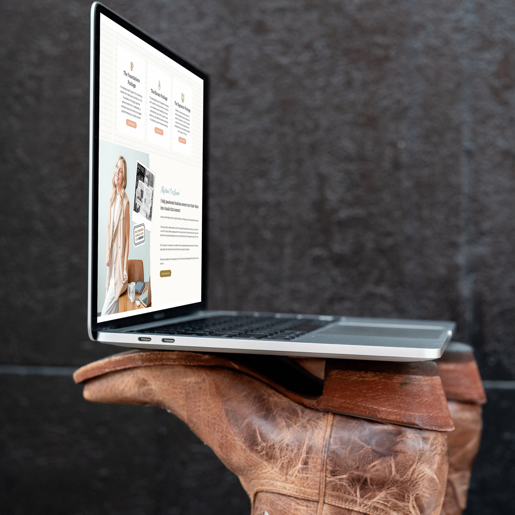 blender creative co website on laptop on top of cowgirl boots